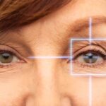 close up of senior woman eyes with laser light